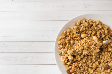 Dry Breakfast of oat flakes, granules and nuts. Muesli in a deep dish. Copy space.
