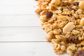 Dry Breakfast of oat flakes, granules and nuts. Muesli on a light table. Copy space