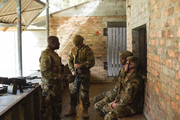 Military men talking indoors