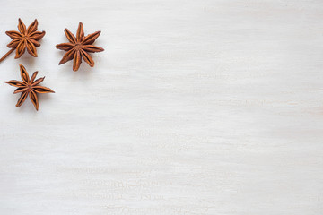 Anise stars on a light background. Fragrant spices star anise. Copy space for text.