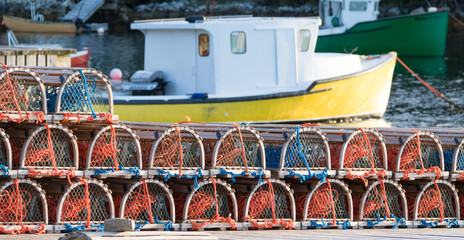 Fototapeta na wymiar lobster traps with boat blurred in background