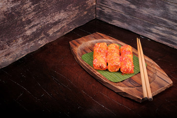 Traditional Malaysian food. Popia on wooden background. Coffee time concept
