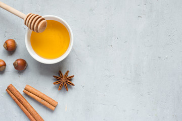 Honey liquid and anise with cinnamon on a light background. Copy space for text.