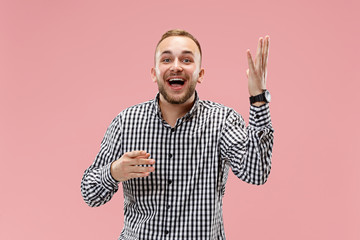 Fototapeta premium Happy business man standing and smiling isolated on pink studio background. Beautiful male half-length portrait. The human emotions, facial expression concept.