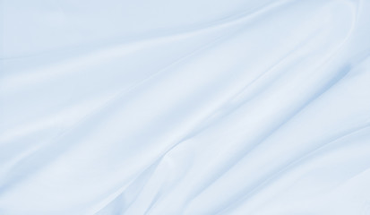 Smooth elegant blue silk or satin luxury cloth texture as abstract background. Luxurious background design