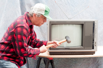 Man breaking up an old TV