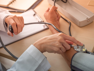 Obraz na płótnie Canvas healthcare concept.Doctor measuring blood pressure of male patient