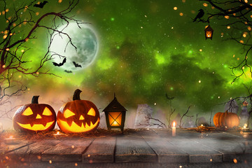 Halloween pumpkins on dark spooky forest.