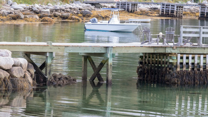 Fototapeta na wymiar dock at low tide with boat in background