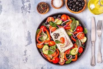 Greek salad of fresh cucumber, tomato, sweet pepper, spinach, red onion, feta cheese and olives