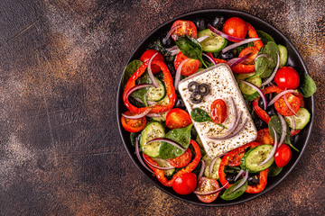 Greek salad of fresh cucumber, tomato, sweet pepper, spinach, red onion, feta cheese and olives