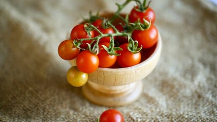 small ripe red cherry tomatoes in a wooden bowl - Powered by Adobe