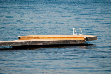 Wooden dock with a white ladder