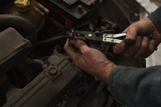 Male mechanic servicing a car in garage
