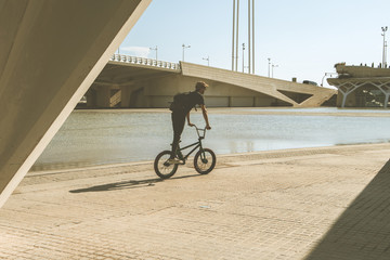 Guy riding BMX in the city.Boy riding a bike through the city