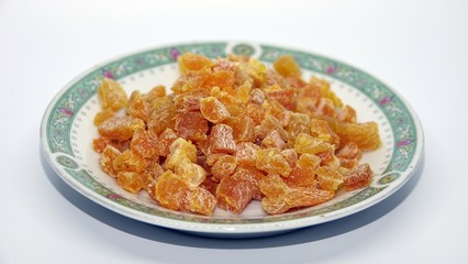 chopped apricots on turkish plate on white background