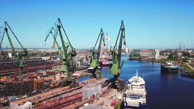 Drone flying around the cranes in the shipyard