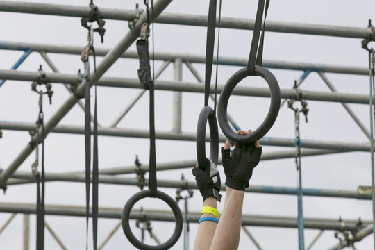 A person on hanging rings during an adventure obstacle course race
