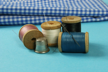 wooden spools with colored cotton threads for sewing, vintage