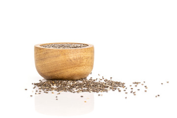 Lot of whole fresh mottled chia seeds with wooden bowl isolated on white background