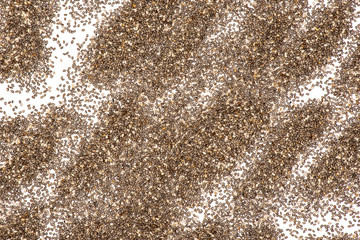 Lot of whole fresh mottled chia seeds abstract flatlay isolated on white background
