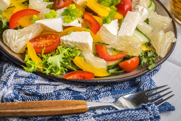 Salad with cheese and fresh vegetables.