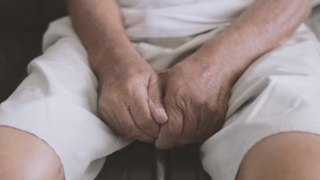 Cinematic shot Closeup of an Elderly man's hands holding a cane.