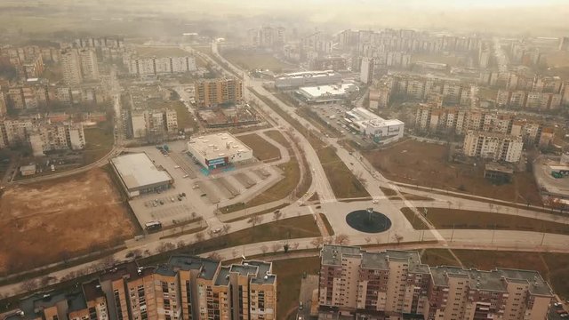 Flying over a concrete living apartment area in east Europa with many birds flying around the drone