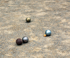 Fototapeta na wymiar Balls of petanque on the sand during the game.