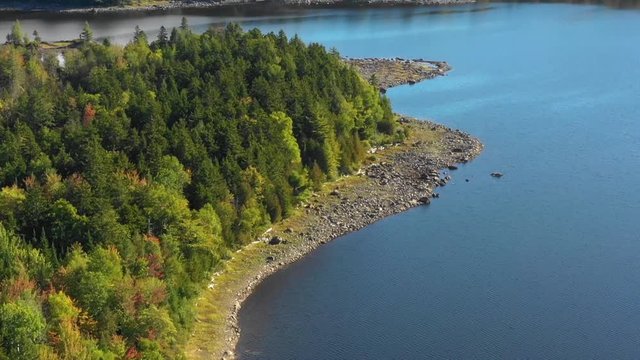 Aerial footage of remote lake in northern Maine after a dry summer DOLLY ZOOM towards rocky peninsula