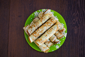 Pancakes rolls with cottage cheese on the plate. Pancakes with cheese. Shrovetide.