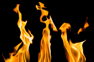yellow sparks of three bright flames on black
