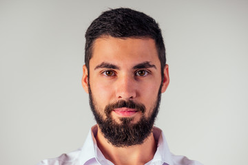 Fototapeta premium portrait of black bearded handsome man with brown eyes in the studio on a white background