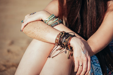 close up hands with boho accessories