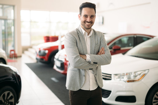 Portrait of happy customer buying new car