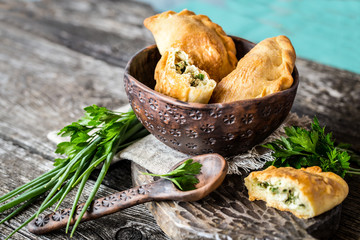 baking with vegetables and herbs in a clay plate on a wooden Board in a rustic style
