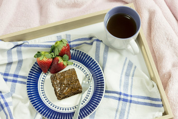 Coffee with brownie and strawberries