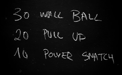 workout of the day on a blackboard in a crossfit gym / WOD