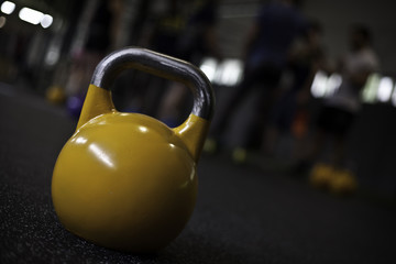 Fototapeta na wymiar yellow kettlebell on the floor in a crossfit gym