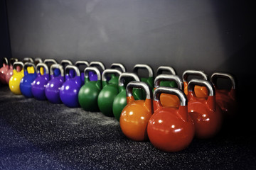 Naklejka na ściany i meble colorfull kettlebells in a crossfit gym