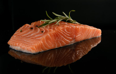 Salmon fresh on a black glossy background