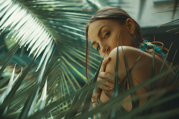 Portrait exotic woman among tropical plants, fashion, beauty, co