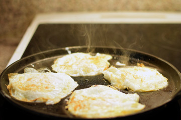 Fried eggs on egg pan, Copy space.