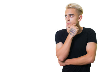 handsome trendy young guy in a black shirt on a white background. pensive looking away