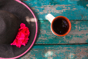 Elegant summer hat and cup of tea