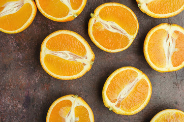 Halves of oranges on a dark.