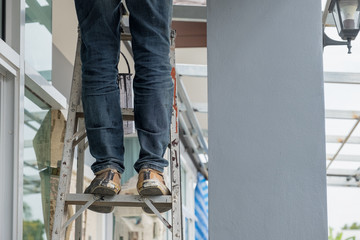 Construction worker standing on aluminium stairs