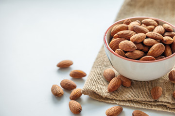 Almonds in cup on sack