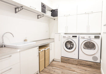 Laundry room with washing machine and dryer in modern house