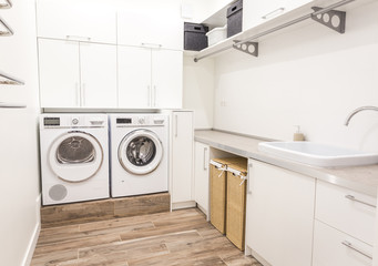 Laundry room with washing machine in modern house